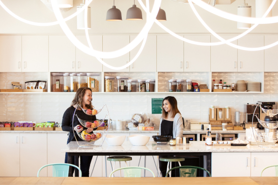 Two Clover Health employees talking in the Jersey City office