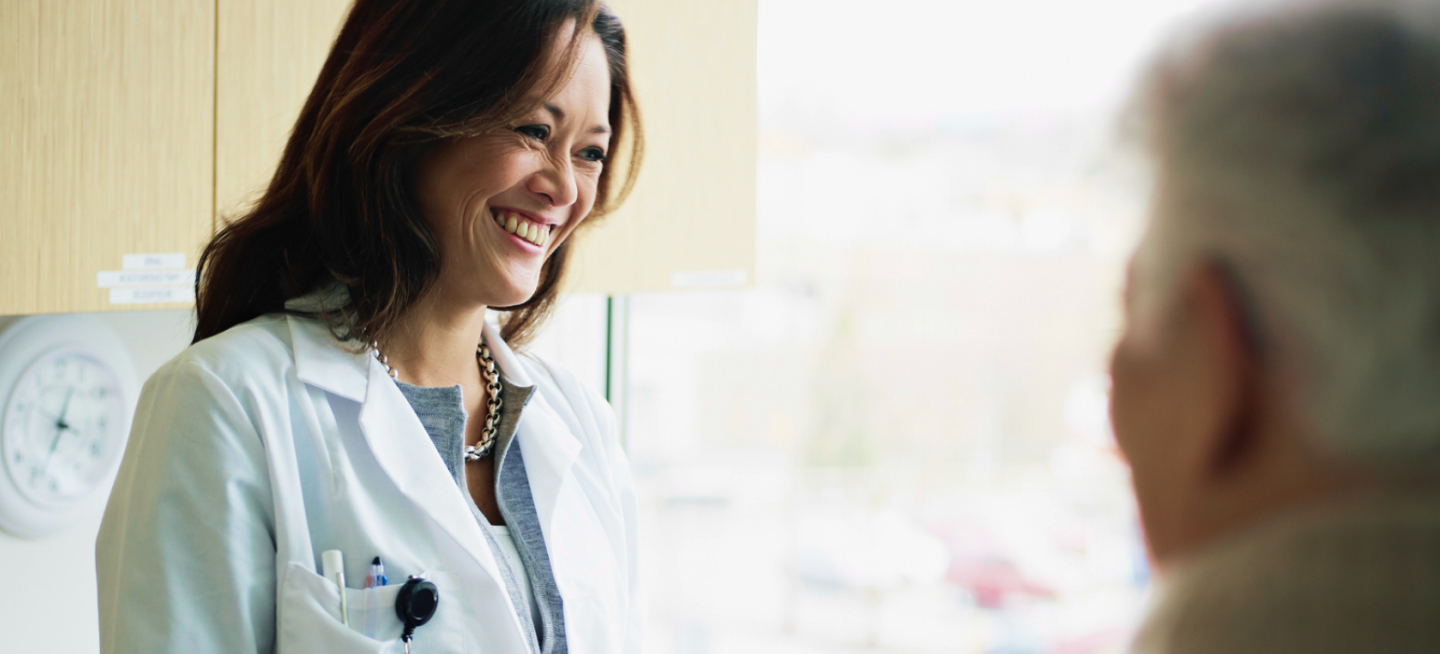 Doctor in an exam room smiling