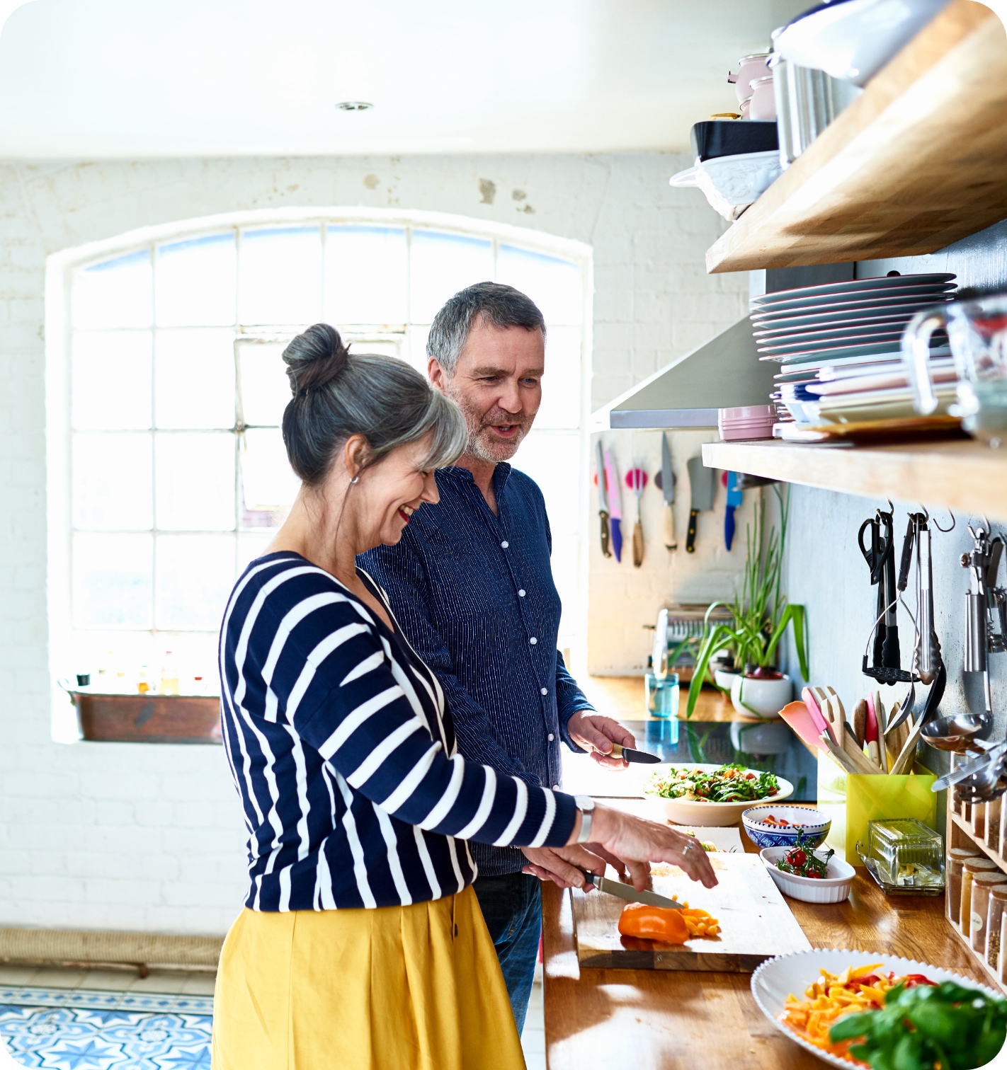 couple cooking in a brightly lit kitchen